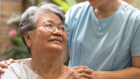 Older woman being comforted.